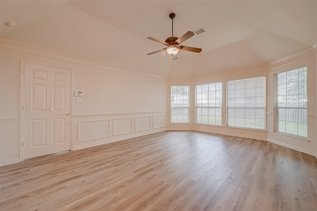 spare room with light wood-type flooring, a raised ceiling, and ceiling fan