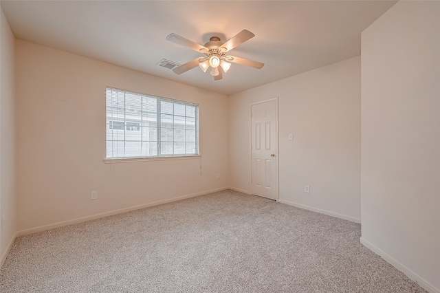 empty room featuring carpet flooring and ceiling fan