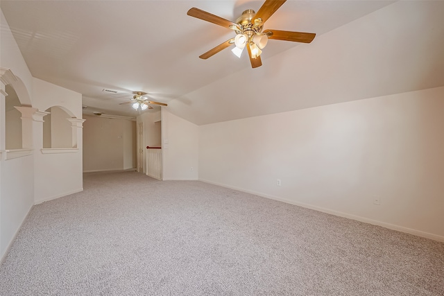 empty room featuring lofted ceiling, light colored carpet, and ceiling fan