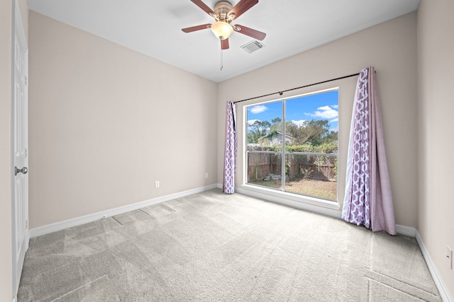 empty room featuring ceiling fan and light colored carpet