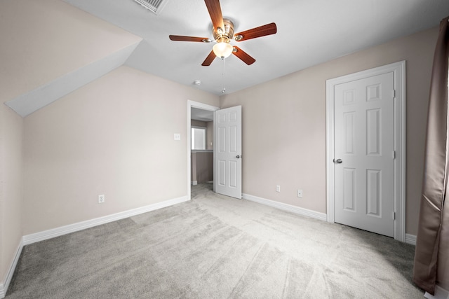 unfurnished bedroom featuring ceiling fan, light carpet, and lofted ceiling