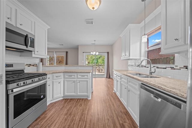 kitchen featuring appliances with stainless steel finishes, white cabinetry, and sink