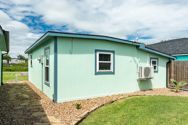 view of home's exterior with a lawn and ac unit