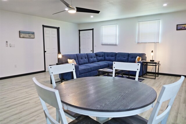 dining area with light wood-type flooring and ceiling fan