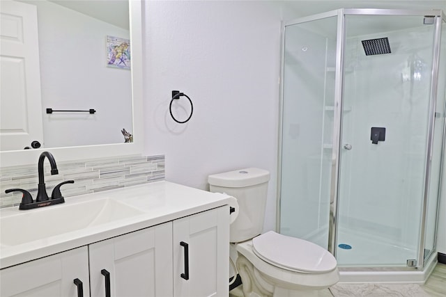 bathroom with vanity, toilet, and a shower with door