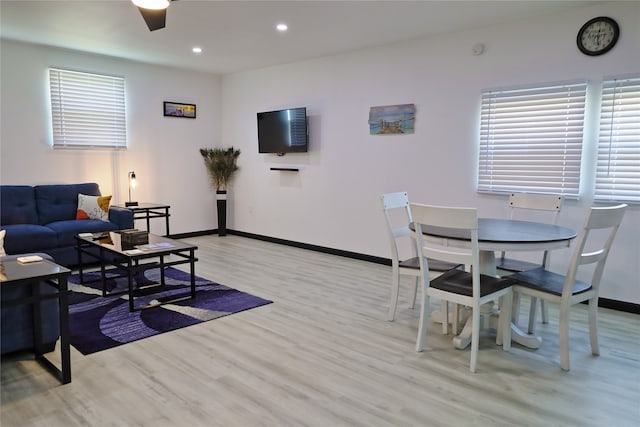 living room with a wealth of natural light, ceiling fan, and light hardwood / wood-style floors