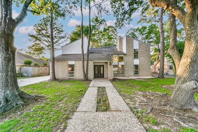 view of front of house featuring a front lawn and french doors