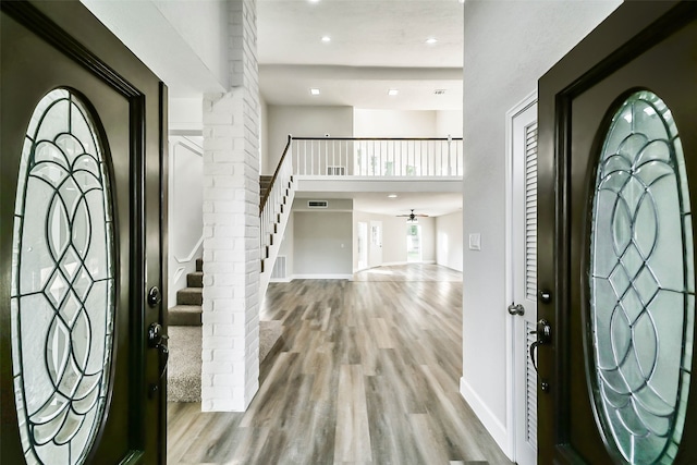 foyer with ceiling fan and light wood-type flooring