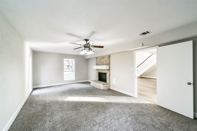 unfurnished living room featuring a fireplace, ceiling fan, and carpet flooring