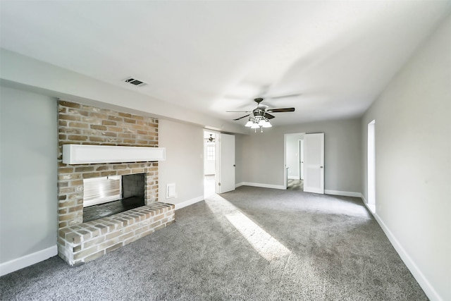 unfurnished living room featuring ceiling fan, carpet floors, and a brick fireplace