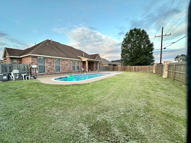 view of yard featuring a fenced in pool and a patio