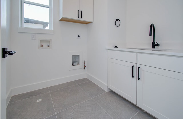 laundry area with electric dryer hookup, gas dryer hookup, light tile patterned floors, washer hookup, and sink