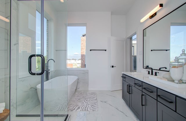 bathroom featuring vanity and shower with separate bathtub