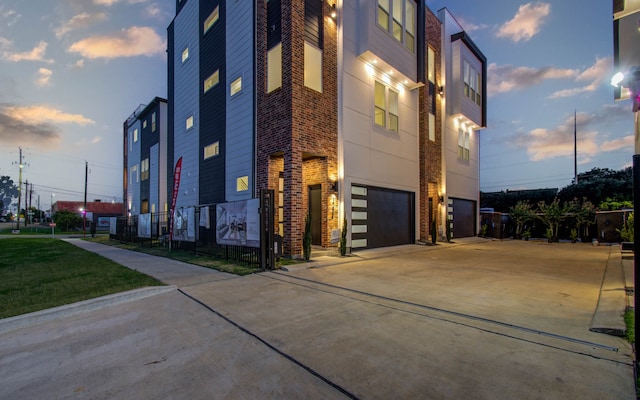 outdoor building at dusk featuring a garage