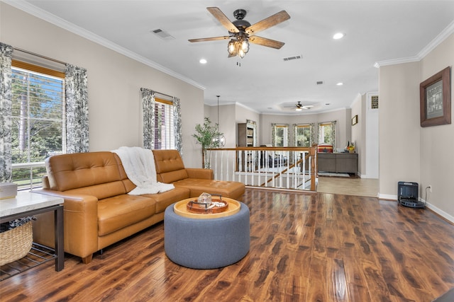 living room with hardwood / wood-style flooring, ceiling fan, and crown molding