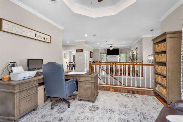 office featuring ceiling fan, ornamental molding, and light hardwood / wood-style flooring