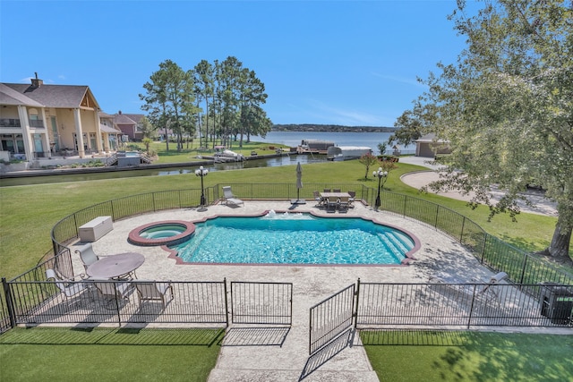 view of swimming pool with a patio area, an in ground hot tub, a yard, and a water view