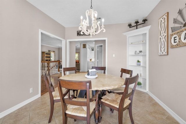 dining space featuring baseboards, a chandelier, and light tile patterned floors