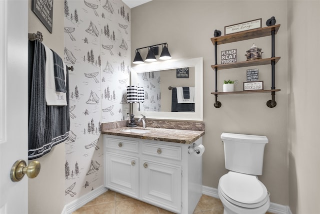 bathroom featuring wallpapered walls, toilet, vanity, and tile patterned floors