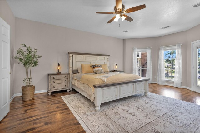 bedroom featuring baseboards, visible vents, dark wood-style flooring, and access to exterior