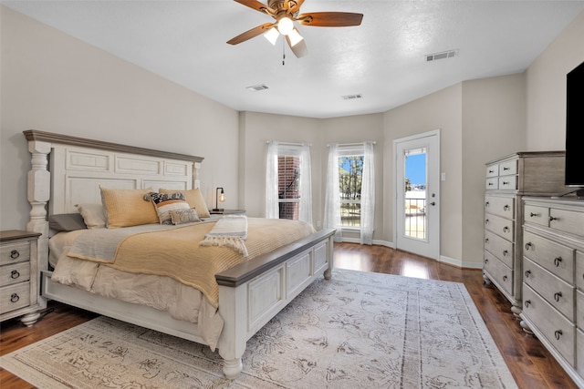 bedroom with ceiling fan, dark hardwood / wood-style flooring, and access to outside