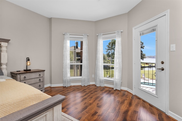 bedroom featuring access to exterior, dark wood-style floors, and baseboards