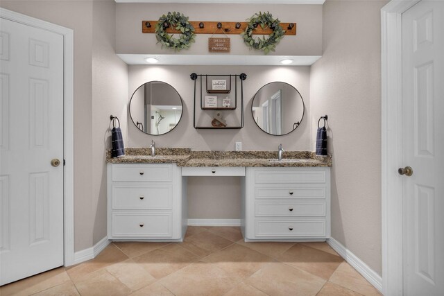 bathroom with tile patterned flooring and vanity