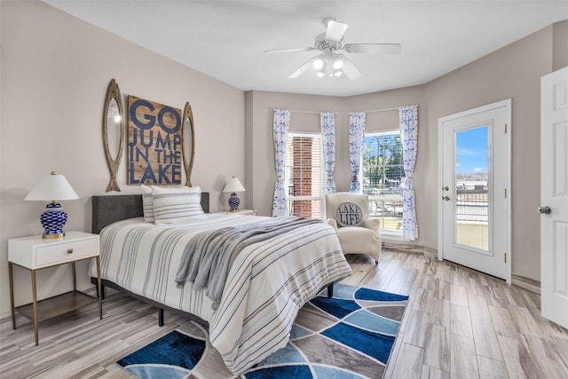 bedroom featuring access to outside, light hardwood / wood-style flooring, and ceiling fan