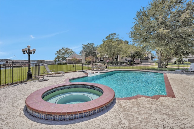 view of pool with a yard and an in ground hot tub