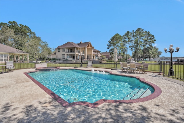 view of pool featuring a patio area and an in ground hot tub