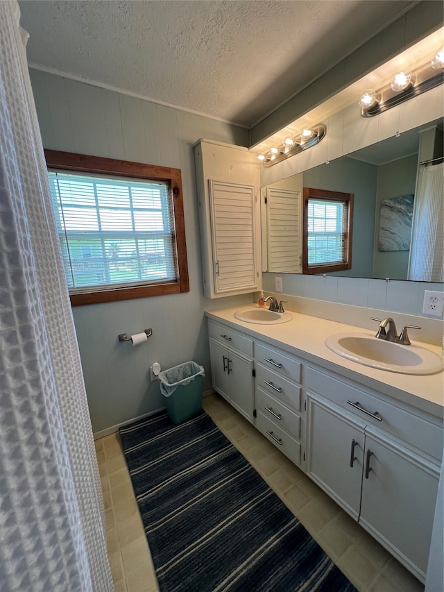 bathroom featuring tile patterned floors, a textured ceiling, and vanity