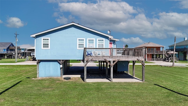 back of property with a deck and a lawn