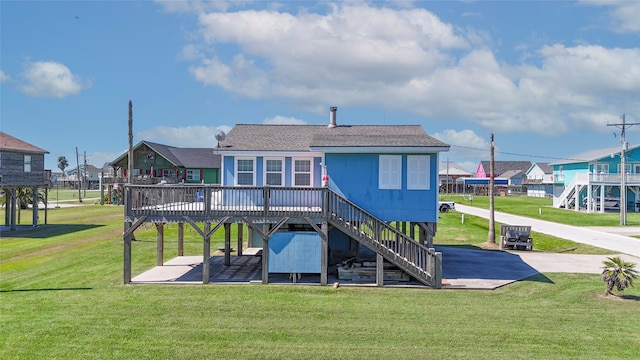 back of property with a lawn and a deck