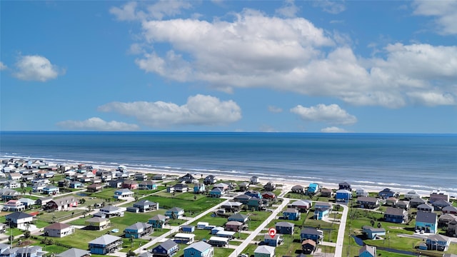 drone / aerial view featuring a water view and a view of the beach