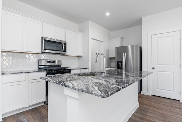 kitchen featuring an island with sink, stainless steel appliances, sink, white cabinetry, and dark hardwood / wood-style flooring