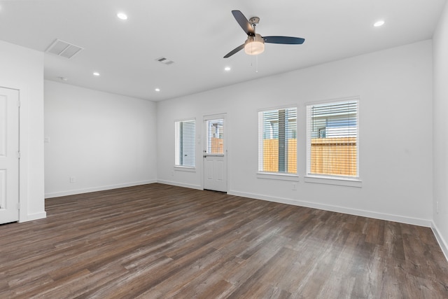 empty room featuring dark wood-type flooring and ceiling fan