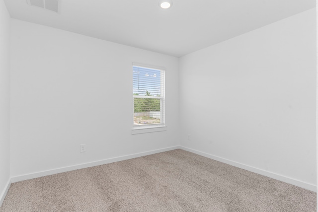 unfurnished room featuring carpet