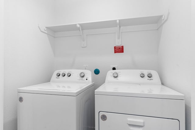 clothes washing area featuring separate washer and dryer