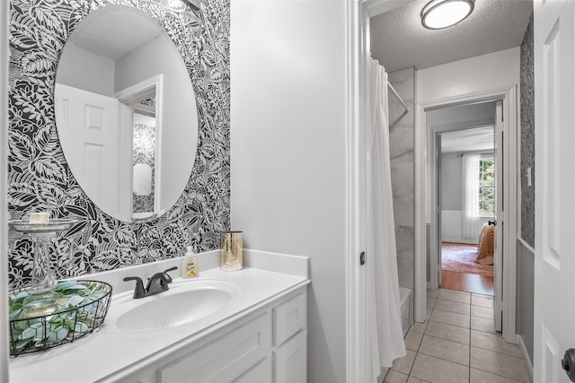 bathroom featuring a textured ceiling, vanity, hardwood / wood-style flooring, and shower / bathtub combination with curtain