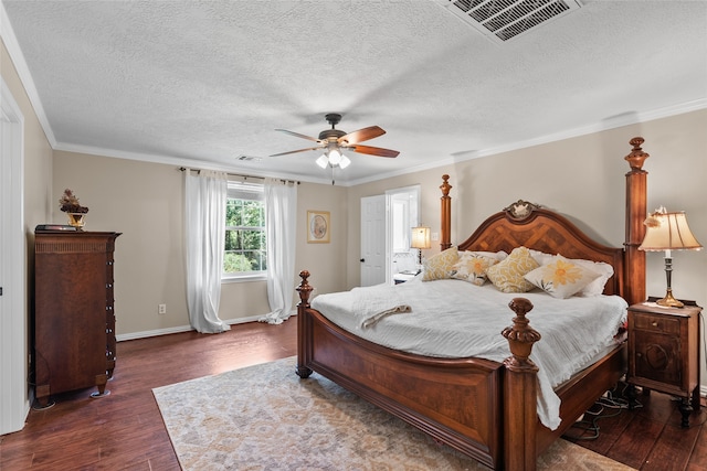 bedroom featuring ceiling fan, dark hardwood / wood-style floors, a textured ceiling, and ornamental molding