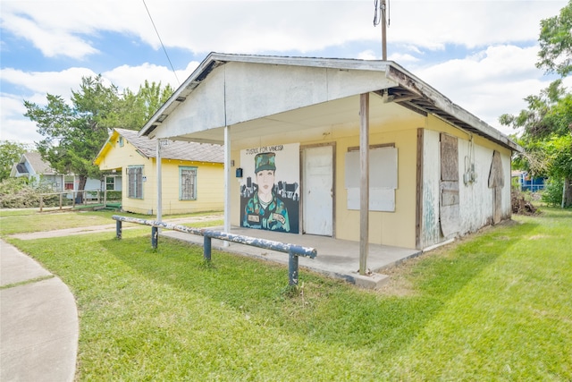 view of side of home featuring a lawn