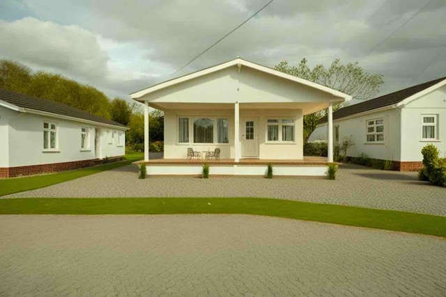 rear view of house featuring a porch