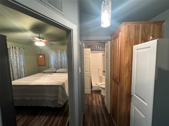 bedroom featuring ceiling fan, dark hardwood / wood-style flooring, and ensuite bathroom