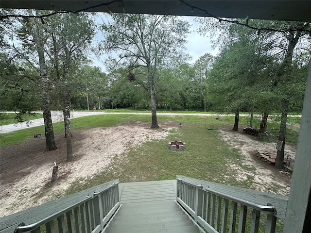 exterior space with a fire pit and a lawn