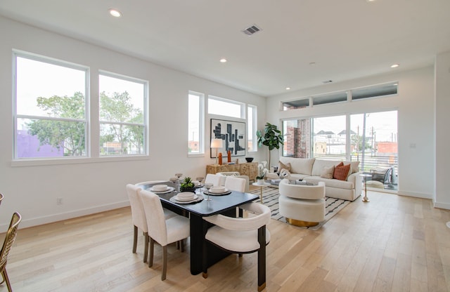 dining area featuring a wealth of natural light and light hardwood / wood-style flooring