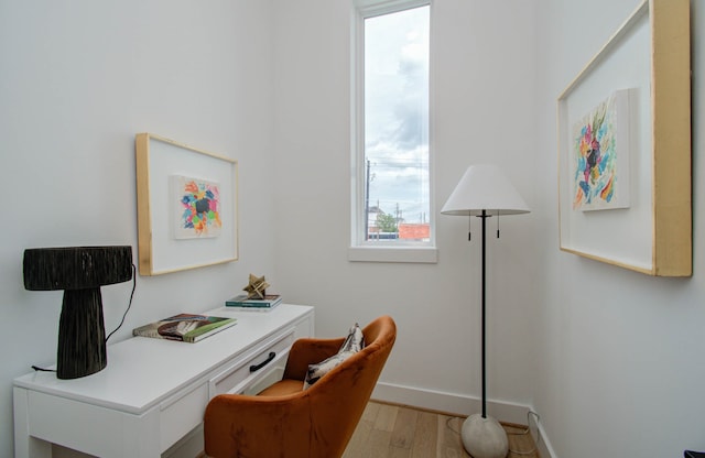 home office with light hardwood / wood-style floors