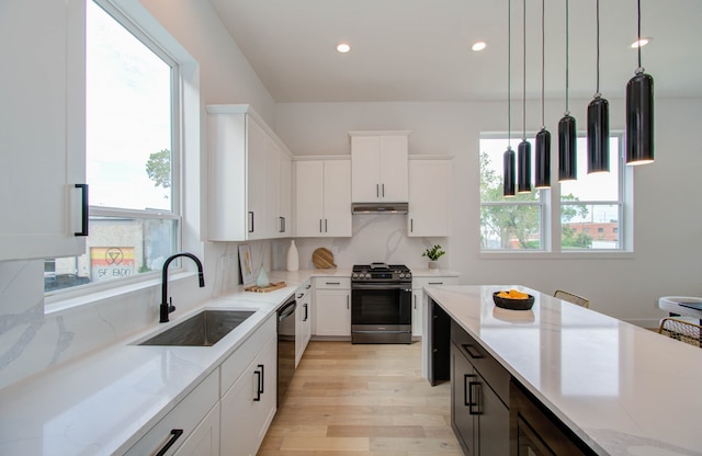 kitchen featuring sink, hanging light fixtures, black dishwasher, stainless steel range with gas cooktop, and plenty of natural light