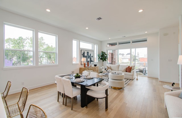 dining area with a healthy amount of sunlight and light hardwood / wood-style floors