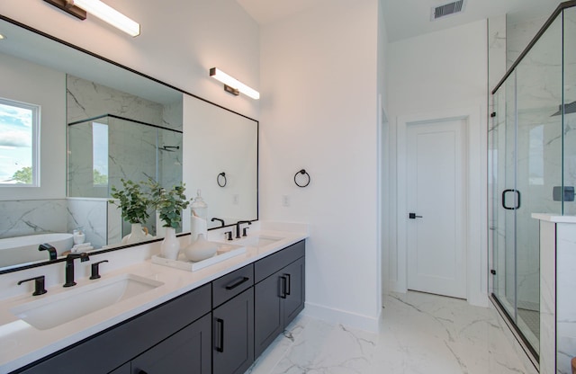 bathroom with vanity and shower with separate bathtub