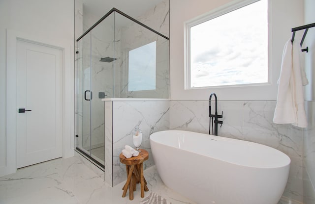 bathroom with separate shower and tub and tile walls